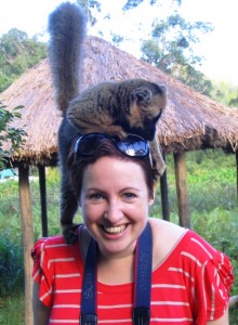 Woman in red and white stripy T-shirt - Cathy Winston, author of family travel blog MummyTravels - with a brown lemur on her head