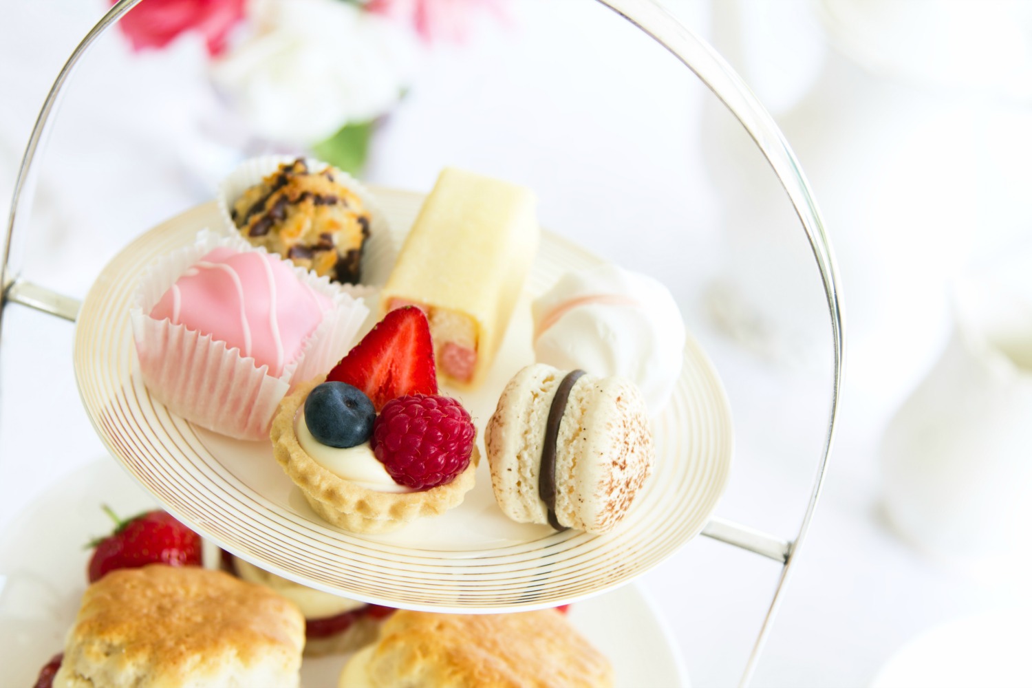 Stand of cakes and scones from a traditional afternoon tea - you can even have afternoon tea, including a Peppa Pig version, on board some of the best bus tours in London with kids
