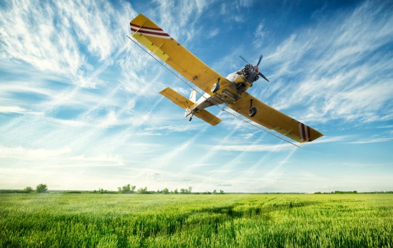 A vintage plane against a blue sky with clouds - tips if you're formula feeding on a plane