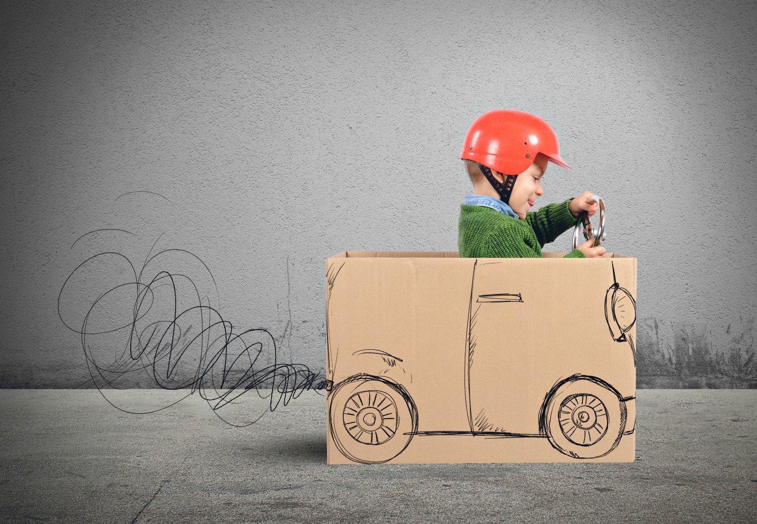 Young boy in a stripy top sitting in a retro style green toy car - my tips for planning a road trip with kids