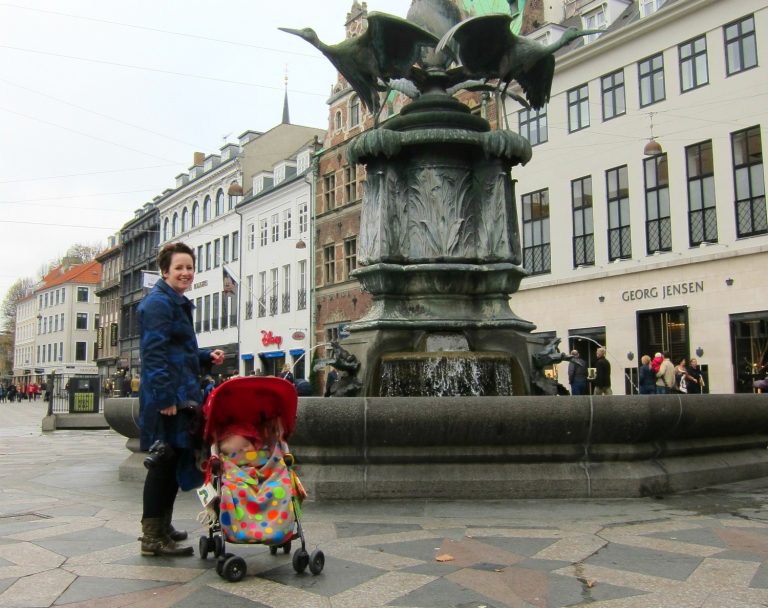 Standing with my sleeping toddler in our travel stroller, tucked up in a Buggysnuggle universal buggy footmuff, while exploring Copenhagen - my review