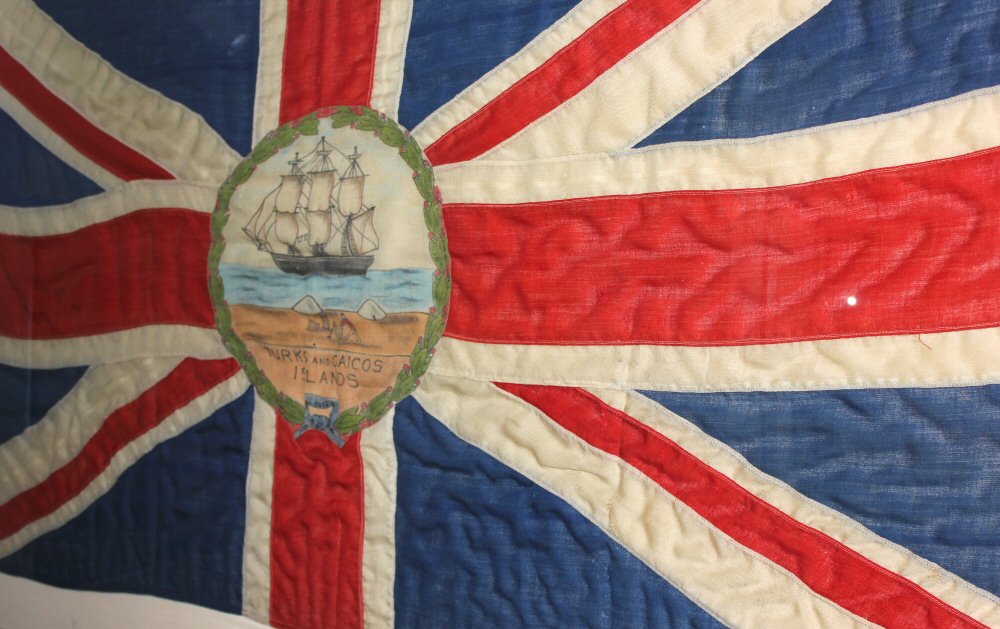 The Turks and Caicos national flag in Grand Turk's museum - our day on the island and discovering the Grand Turk shipwreck