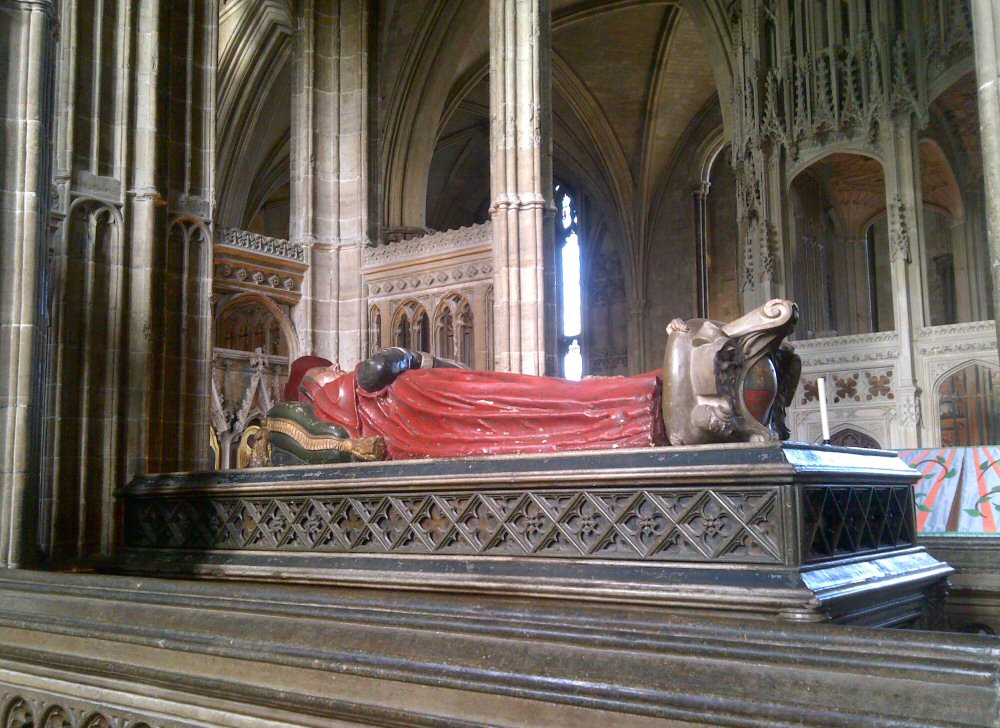 Effigy in ref robes on a tomb in Winchester cathedral
