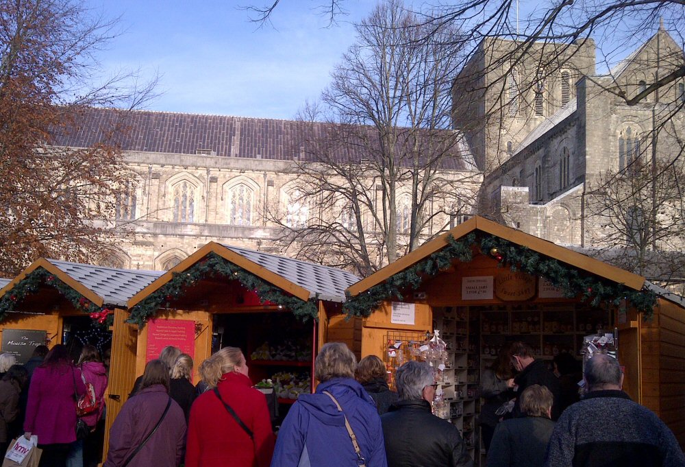 Stalls at Winchester Christmas market with the cathedral in the background