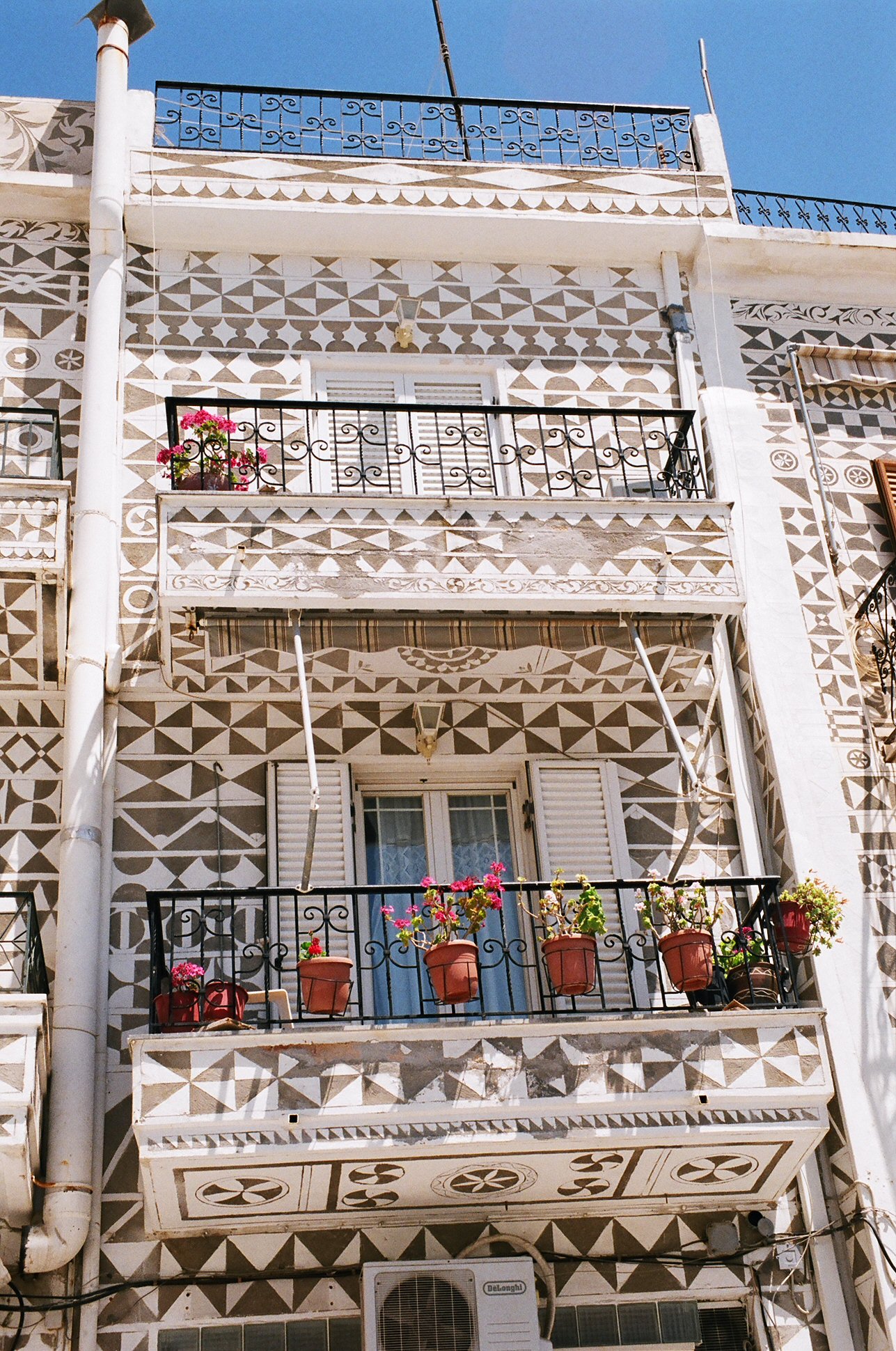 See the black and white decorations on the buildings in Pirgi, Chios, Greece - one of my top things to do in Chios