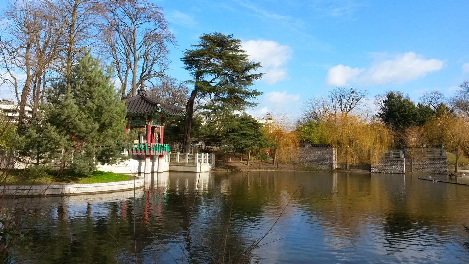 Lake with pagoda and gardens of the Jardin d'acclimatation - the best parks in Paris with kids