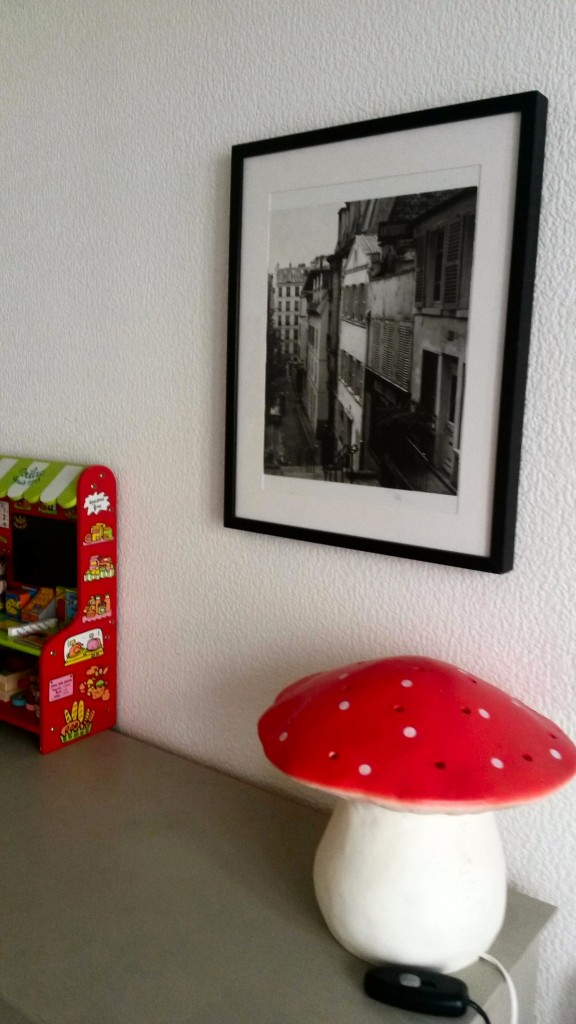 Mushroom lamp and black and white photo near child's toy in our Paris AirBNB