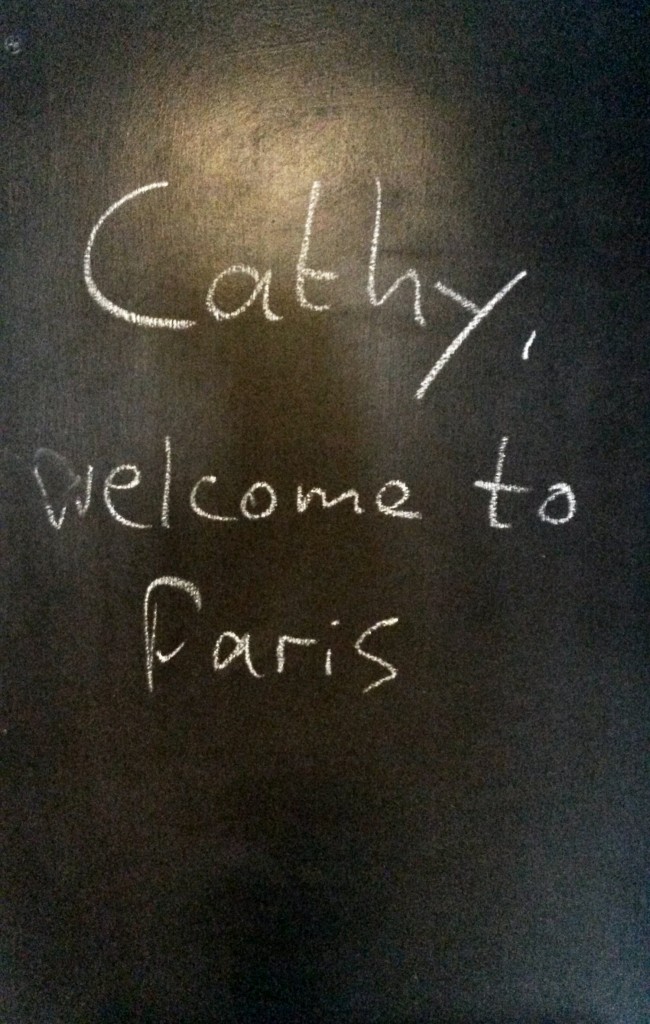 Blackboard reading Cathy welcome to Paris - a warm welcome is part of my recipe for the perfect family holiday