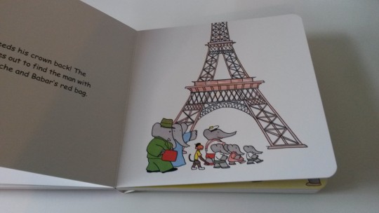 Page from the Babar in Paris book showing the family of elephants in front of the Eiffel Tower