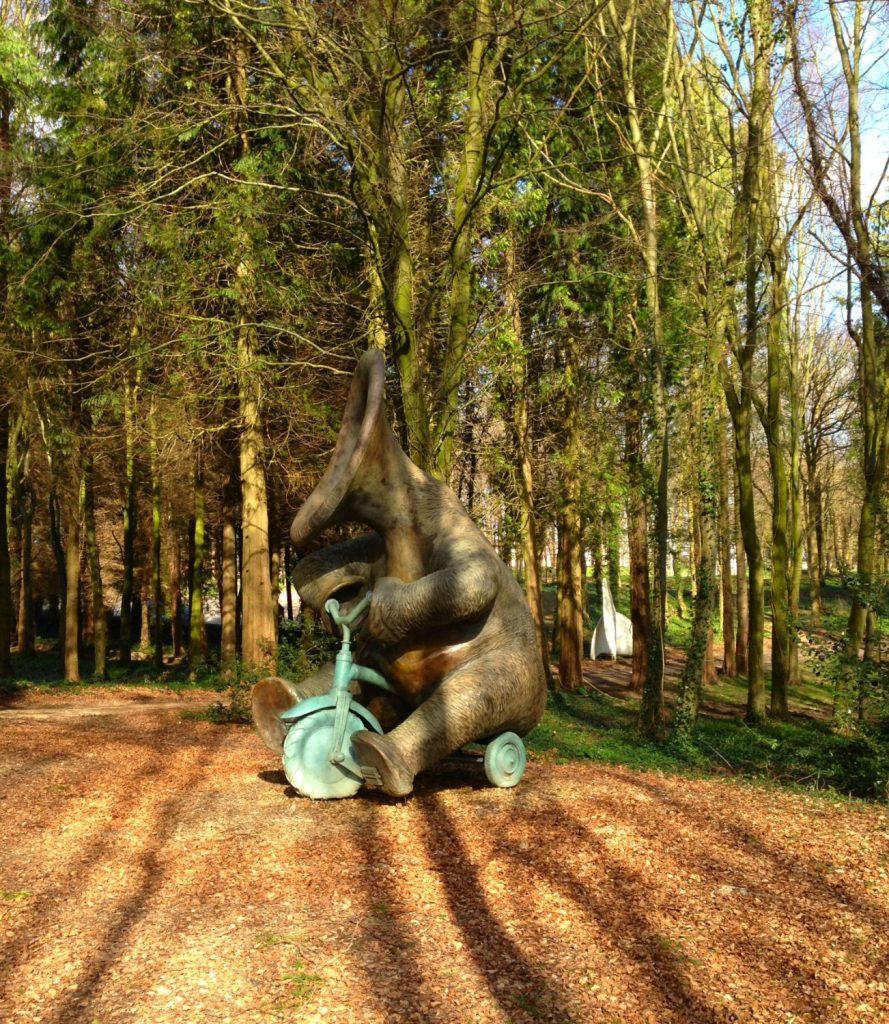A creature riding a bike at Cass Sculpture foundation