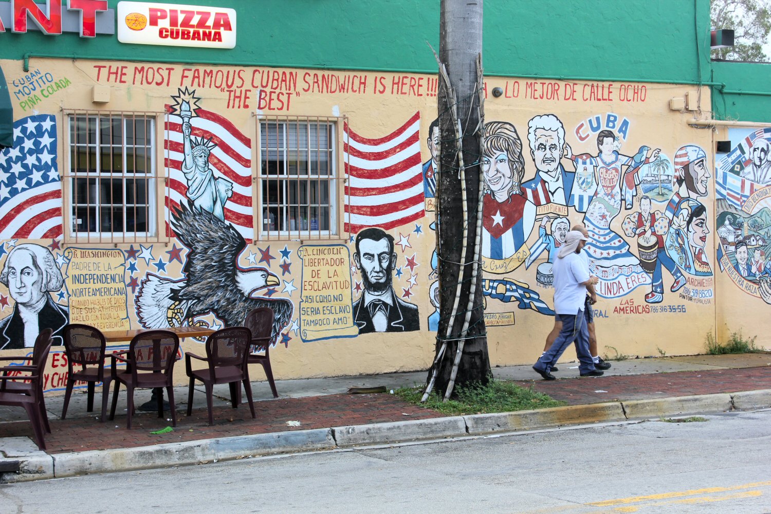 Street art on the side of a building in Little Havana advertising Cuban sandwiches as well as US symbols and famous faces