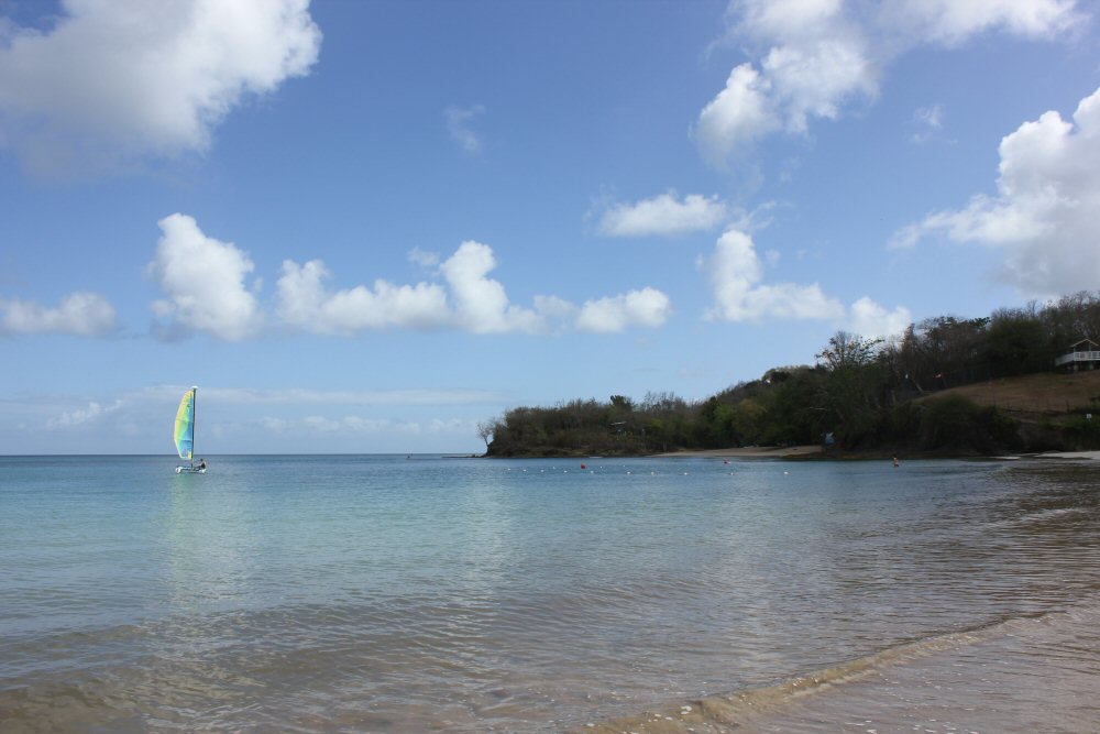 View of the Caribbean from St James Club Morgan Bay with a brightly coloured sail on the horizon - my review of the all-inclusive Caribbean resort