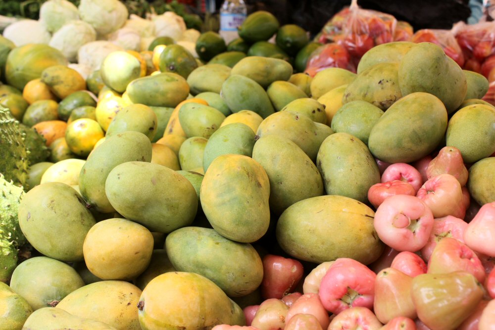 Piles of green and yellow fruit at Castries market - one of my top places to visit in St Lucia with toddlers
