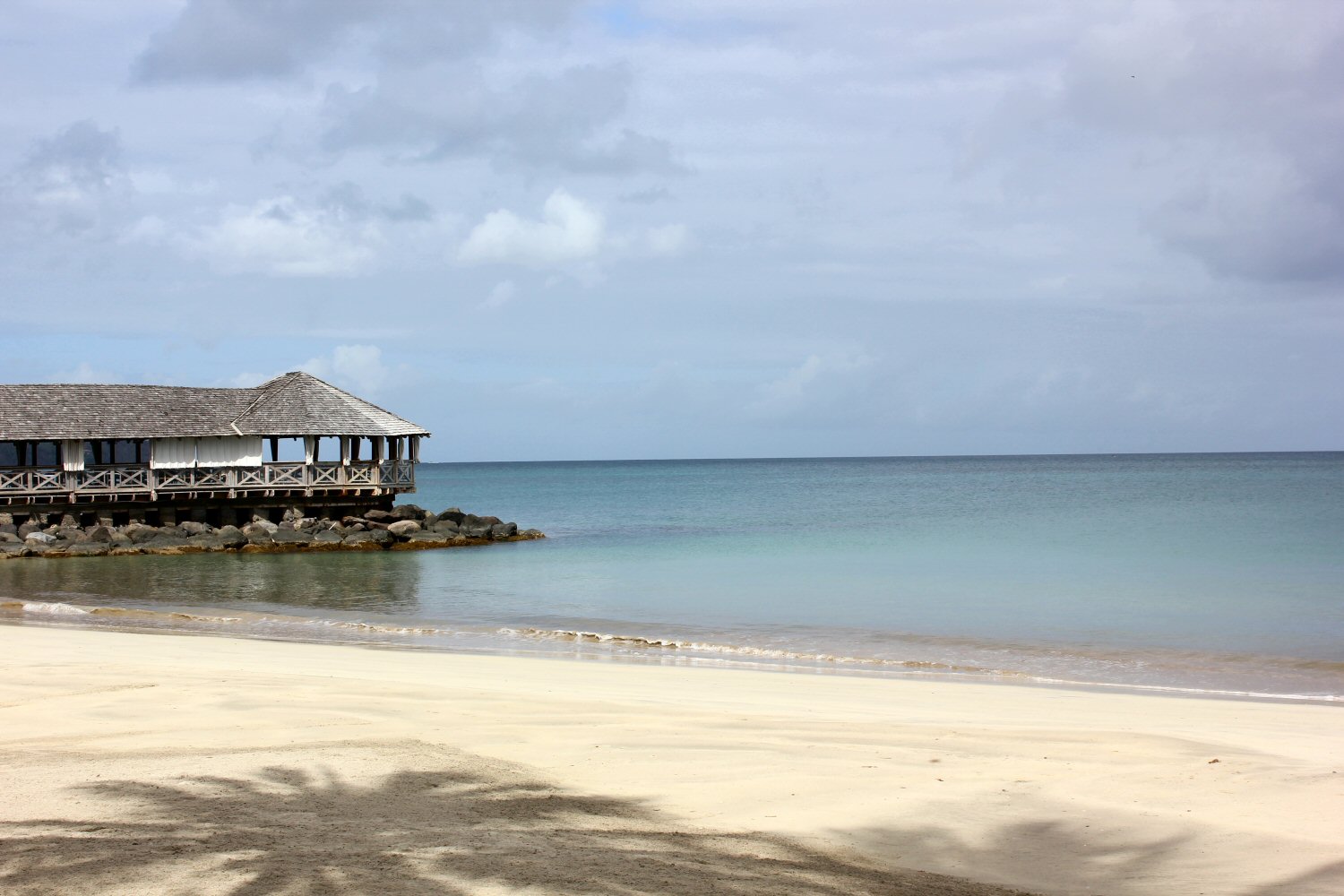 A view of the beach and one of the overwater restaurants - my St James Club Morgan Bay review, after our stay in St Lucia