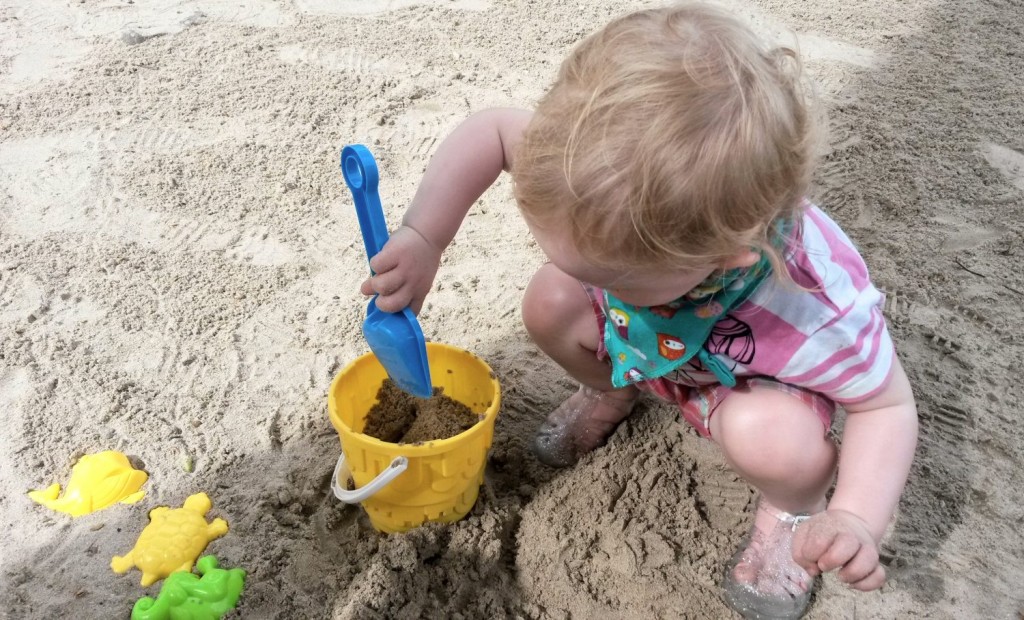 My toddler daughter with bucket and spade on the beach at St James Club Morgan Bay in St Lucia
