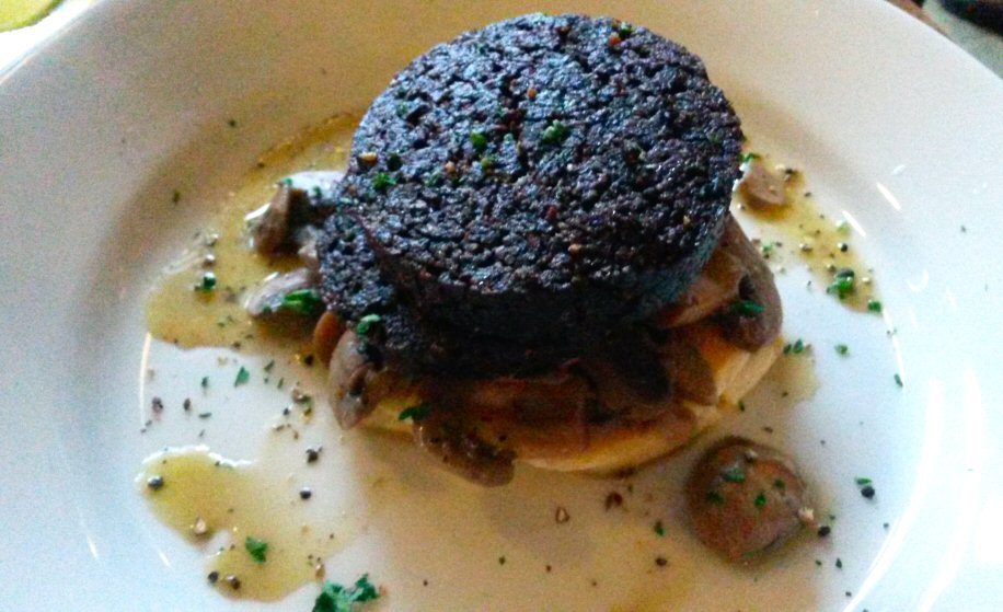 Black pudding topping my dinner at cafe Gandolfi restaurant in Glasgow, including locally sourced ingredients