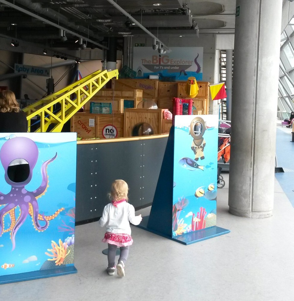 My toddler daughter heads into the building zone at Glasgow Science Centre - one of the top places to visit on a Scotland road trip with kids