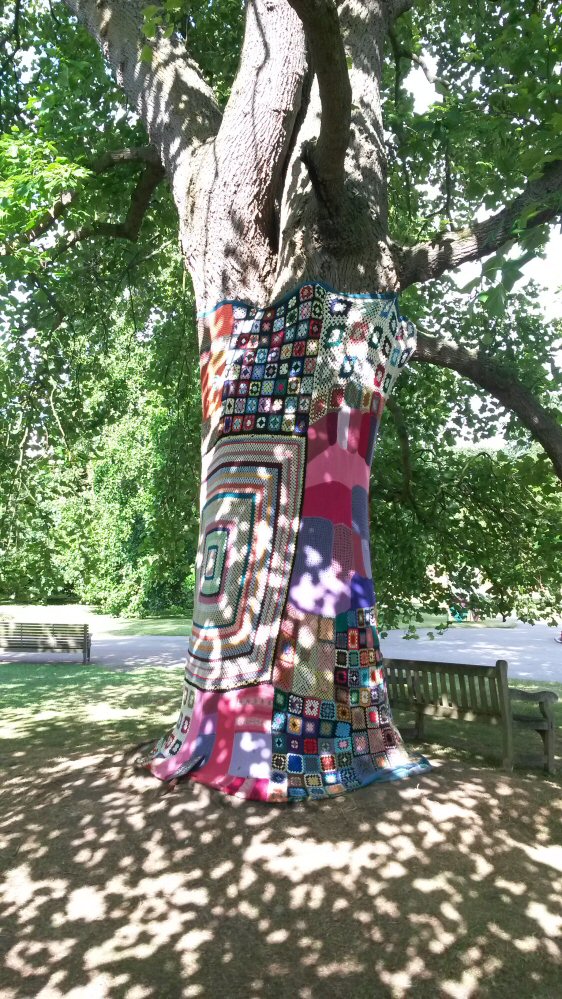 Tree wrapped in a brightly coloured blanket at Kew Gardens