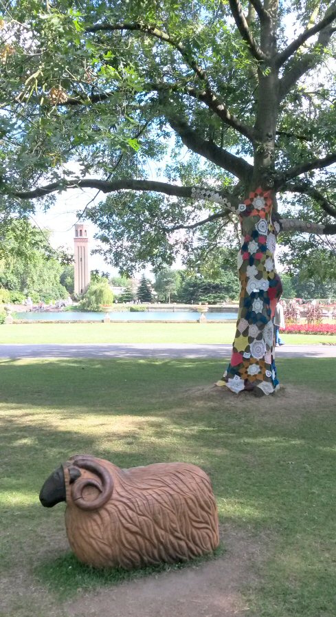 Carved wooden sheep and bright tree at Kew Gardens
