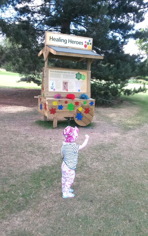 Toddler pointing to one of the Plantasia displays at the Kew Gardens exhibition