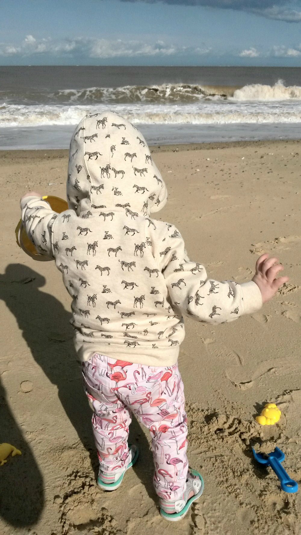 My young daughter on the beach in Suffolk with sand toys - our last trip of the Take 12 Trips challenge