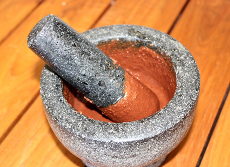 Pestle and mortar with liquid chocolate - discovering the history of chocolate in St Lucia and how to make it