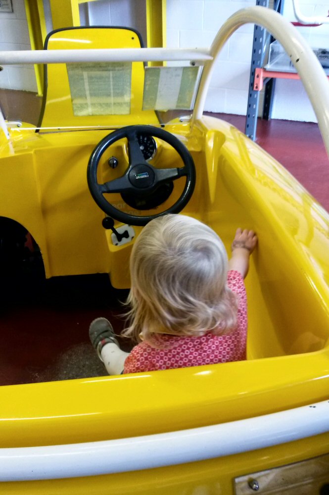 My daughter in a toy car at the National Children's museum - discovering Eureka for toddlers