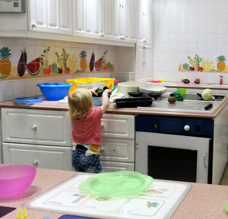 My toddler playing in the toy kitchen at Eureka National Children's museum