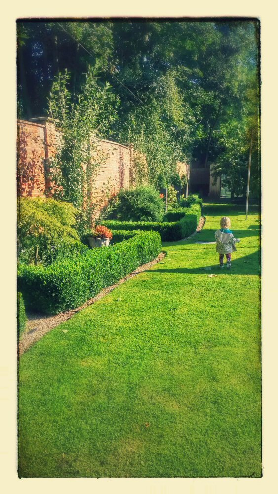 My toddler daughter runs across the lawn at Satis House Hotel, Yoxford