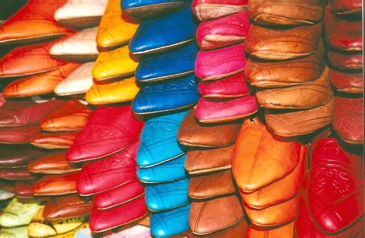 Piles of colourful babouches, the leather slippers worn in Morocco and north Africa, piled up in a souk