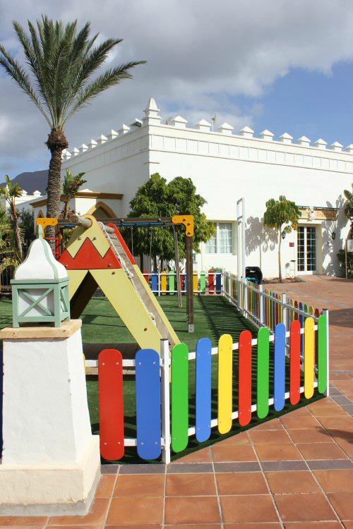Playground behind a brightly coloured fence at the Gran Castillo hotel in Lanzarote