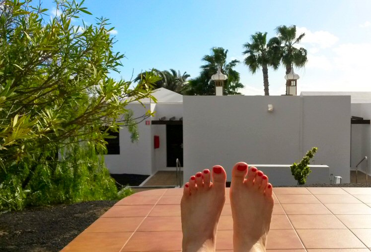 My toes as I relax on a lounger in the sun on the patio of our villa in Lanzarote on holiday - and more of my Lanzarote travel lessons learned