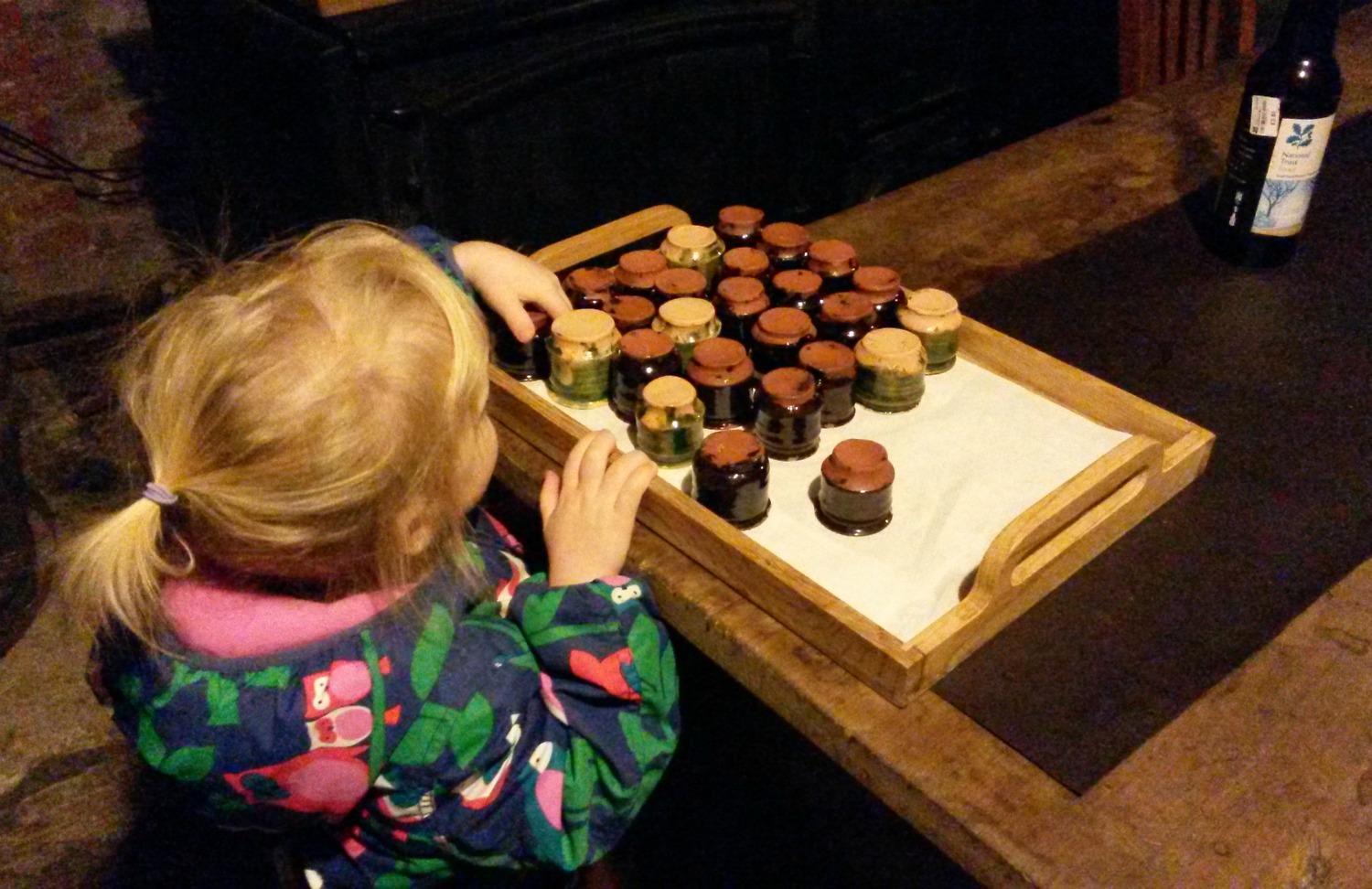 My daughter plays with exhibits on a tray in the beer cellar of Ham House in Surrey