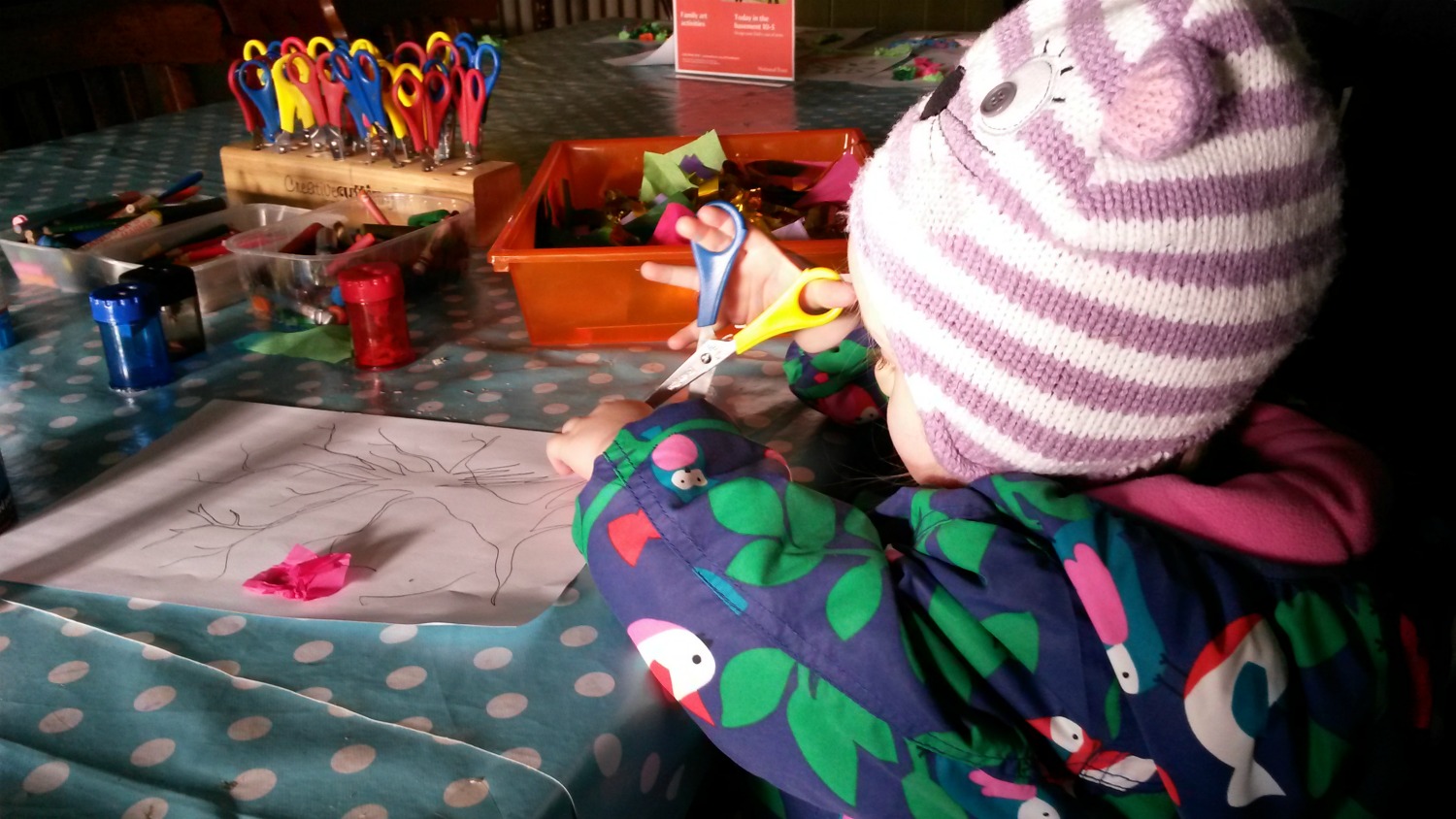 My toddler checking out the craft table at Ham House in Surrey