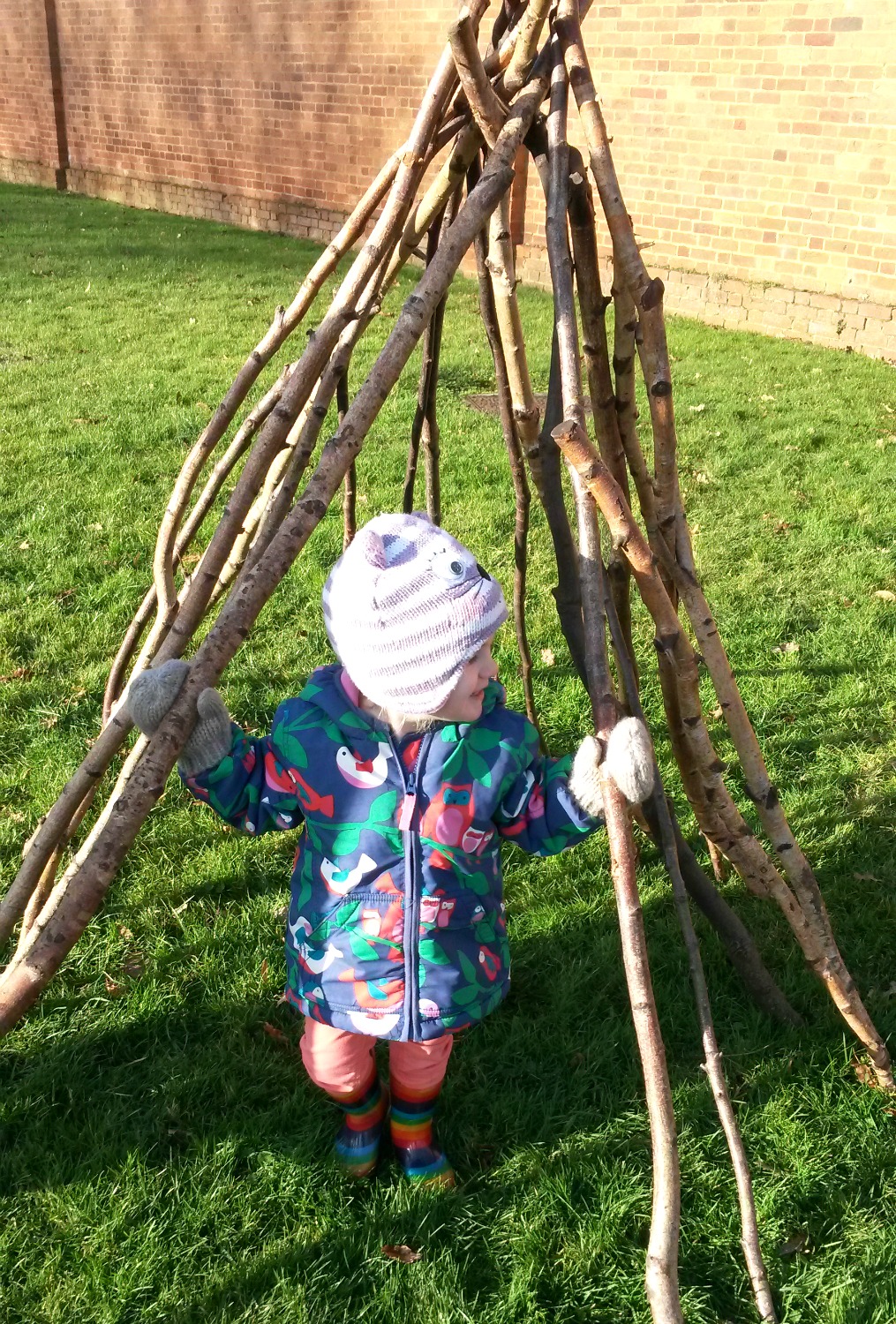 My toddler daughter in her den of sticks at Ham House in Surrey - who needs a Ham House playground when you can make your own?