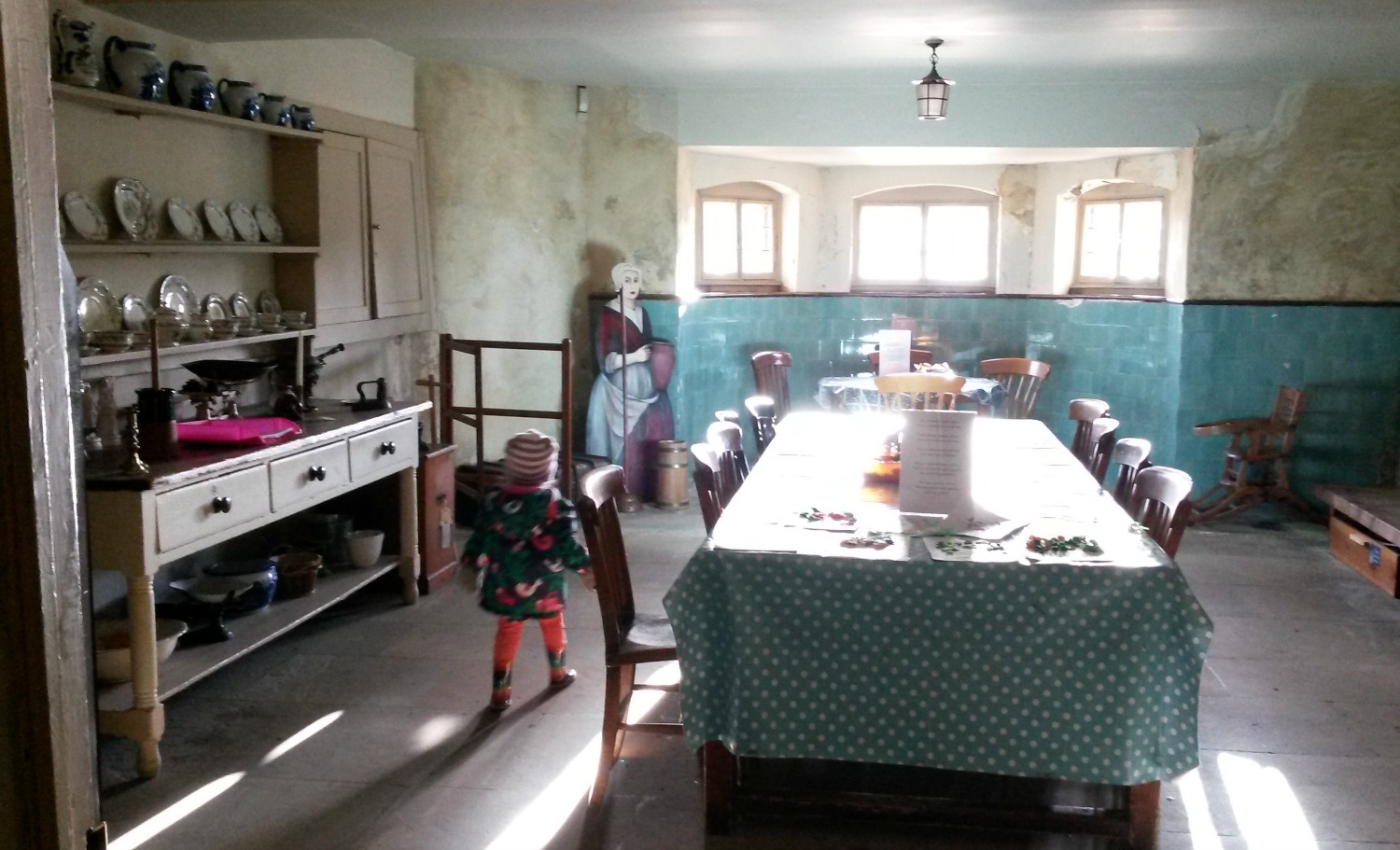 My toddler exploring below stairs in a room set up for the servants at Ham House in Surrey