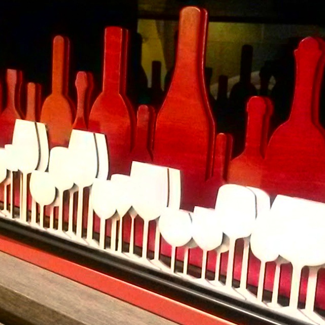 Cut out decor of red wine bottles and white wine glasses at the Mercure London Bridge hotel - my review