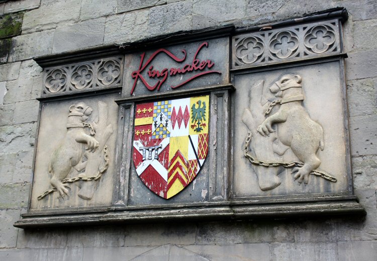 A coat of arms by the entrance to the Kingmaker exhibition - waxwork figures which prove very convincing at Warwick Castle for kids