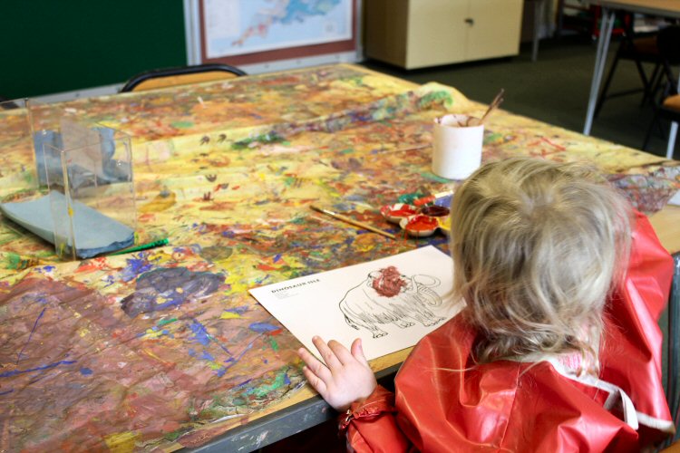 My toddler painting a woolly mammoth in the education room of the Isle of Wight's Dinosaur Isle museum