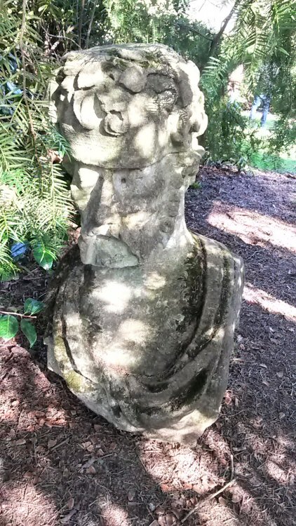 Stone head along one of the paths - a day out at Harcourt Arboretum with a toddler