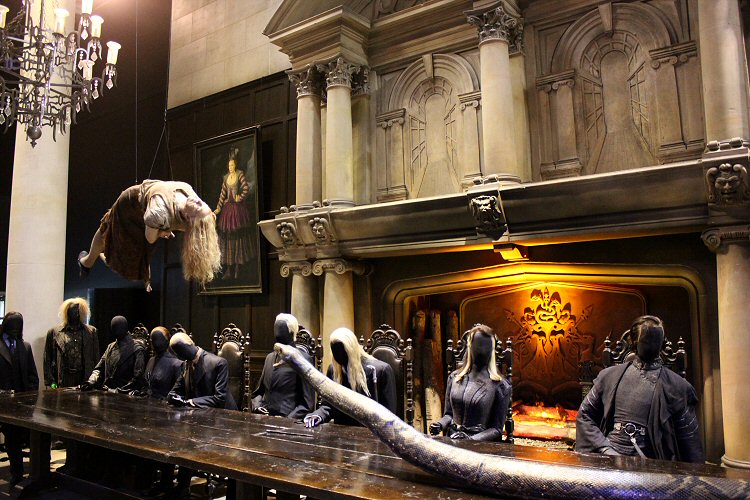 Figures of Death Eaters around the table at Malfoy Manor with a figure suspended above it - in the Dark Arts section on the Harry Potter studio tour
