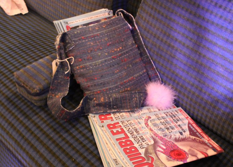 Copy of the Quibbler, pygmy puff and other props on a train seat in the Hogwarts Express