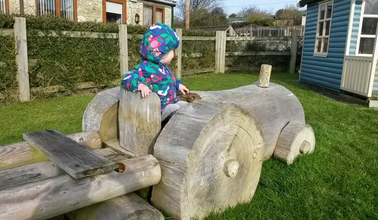 My daughter in the wooden play equipment at Nettlecombe Farm on the Isle of Wight