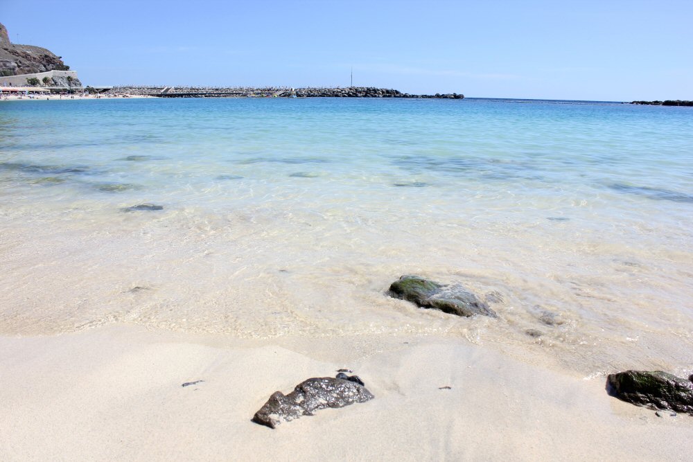 View of the sand and clear water during our final afternoon at the beach in Amadores, Gran Canaria