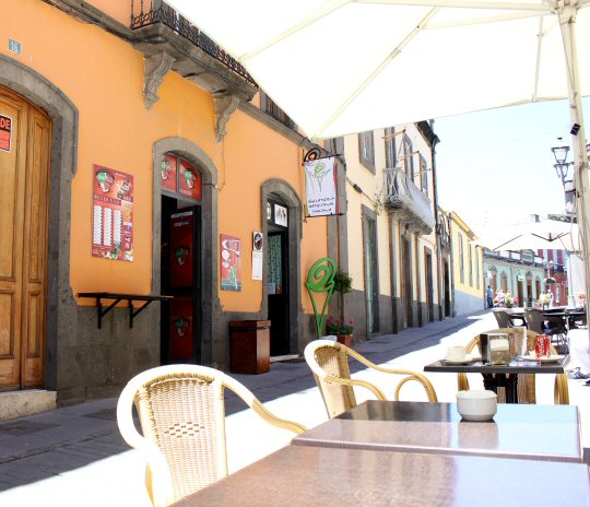 Tables and chairs outside a cafe in one of the streets in Arucas, Gran Canaria
