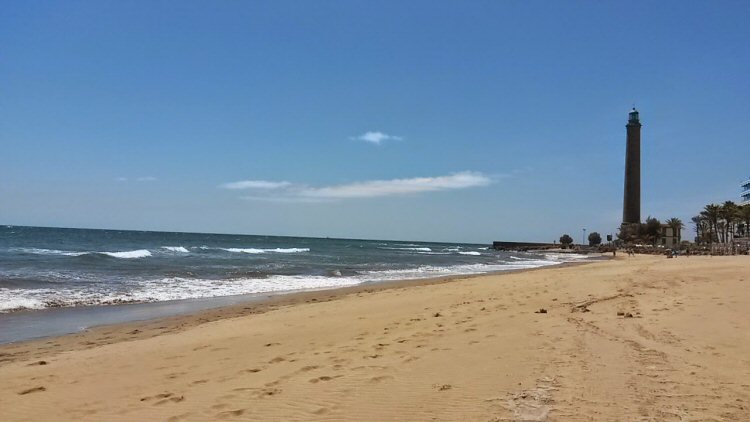 View of the beach and lighthouse in Maspalomas, Gran Canaria