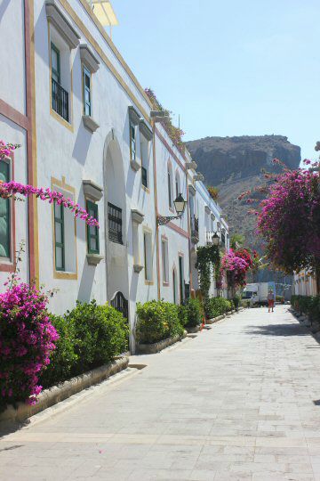 White and pastel houses with pink flowers in Puerto de Mogan, Gran Canaria