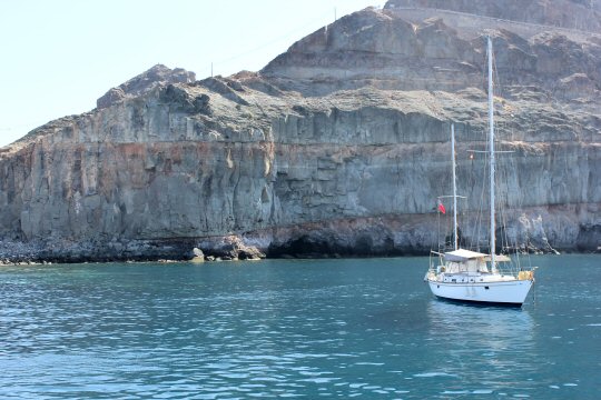 Yacht moored up on the south coast of Gran Canaria by the cliffs during our ferry to Puerto de Mogan