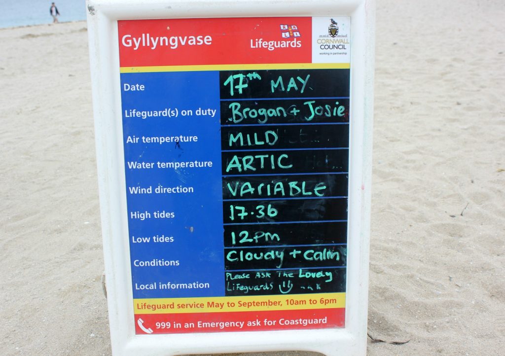 Weather and sea conditions on a board at on Gyllyngvase beach in Falmouth - water temperature given as arctic!