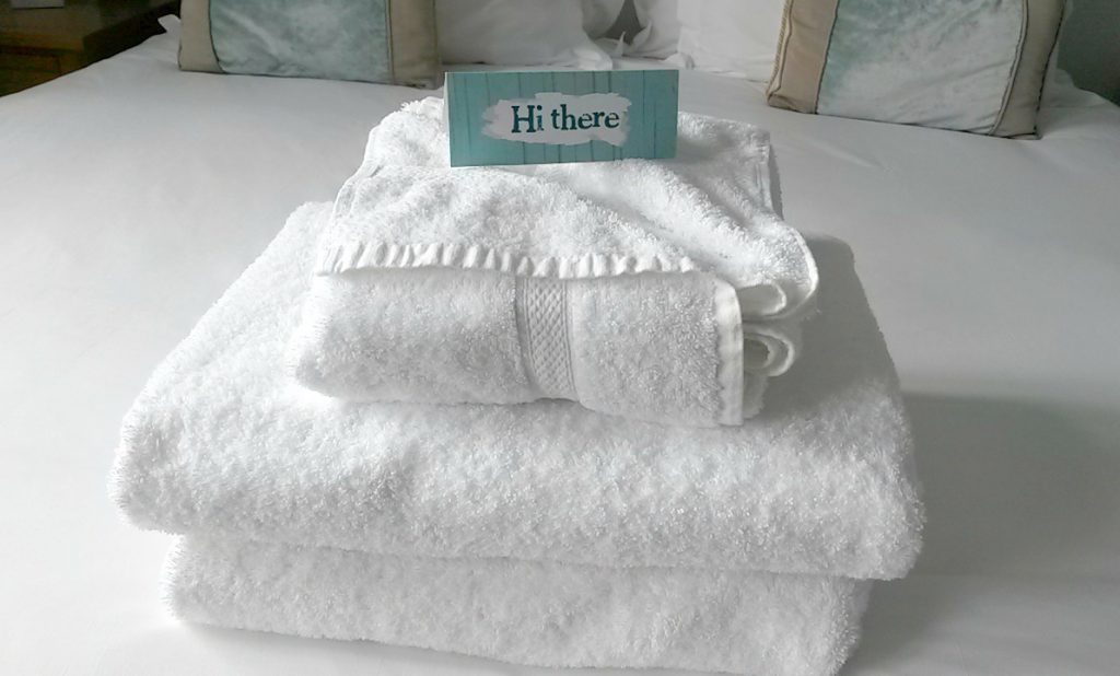 Towels on the bed in our room at St Michael's Hotel in Falmouth